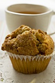 Muffin in front of a cup of tea
