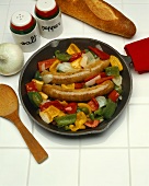 Sausages with Onion and Peppers in a Cast Iron Skillet