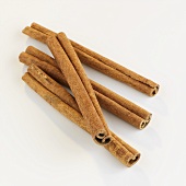 Four cinnamon sticks on white background
