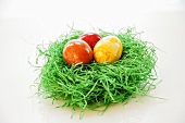Easter nest with three coloured eggs