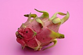 A pitahaya (dragon fruit) on pink background