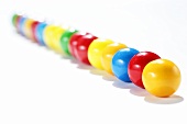 A row of coloured chewing gum balls