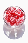 Raspberry sweets in a small glass bowl