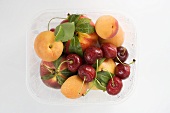 Nectarines, apricots and cherries in plastic punnet