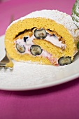 A slice of sponge roulade with berry & quark filling