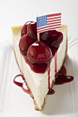 A piece of cheesecake with cherry sauce