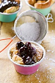 Individual bread puddings with cherries & icing sugar