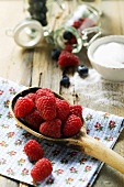 Fresh raspberries on a wooden spoon