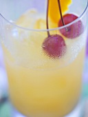 Fruit cocktail with cherries and lemon peel