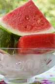 Pieces of watermelon in a bowl of ice cubes
