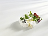 Camembert with herbs, a wedge cut