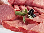 Sliced salami and olives