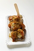 A currywurst (sausage with ketchup & curry powder) with wooden fork