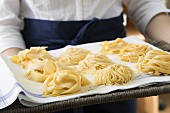 Three types of ribbon pasta on a tray