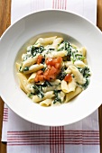Penne with spinach and cream sauce and diced tomato