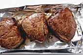 Three fillet steaks on aluminium foil