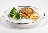 Beef fillet with fried potatoes and vegetables