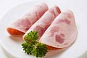 Three slices of Bierschinken (ham sausage) with parsley