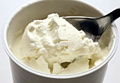 Ein Becher Schafmilch-Joghurt mit Löffel