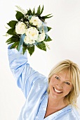 Smiling woman holding bouquet of white roses