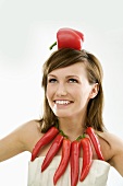 Young woman with necklace of chillies and pepper