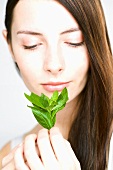 Woman holding fresh basil in her hand