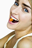 Woman with a chewable tablet in her mouth
