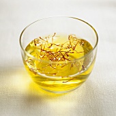 Saffron threads in a small bowl of water