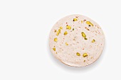 A slice of veal sausage with pistachios