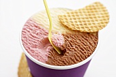 Neapolitan ice cream in tub with wafer