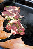 Marinated steaks on grill