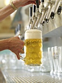 Filling a tankard with draught beer