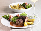 Beef roulades with bacon-wrapped beans and potatoes