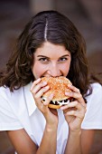 Woman biting into burger