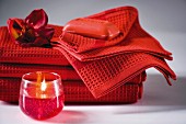 Towels with soap and lit candle