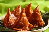 Deep-fried samosas in sugar (sweet snack, India)