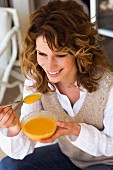 Woman eating mango mousse