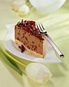 Piece of hazelnut chocolate cheesecake with grated chocolate
