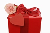 Gift in red wrapping paper with rose