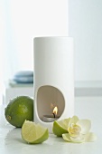 Aroma lamp with limes and orchid flower