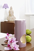 Aroma lamp with limes and orchid flowers