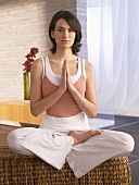 Woman sitting cross-legged practising yoga