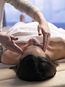 Woman having her temples massaged