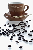 Cappuccino cup and saucer, coffee beans
