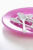 Pink plate and white spoons