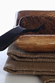 Ground coffee in wooden dish with spoon