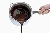 Pouring melted chocolate out of a pan