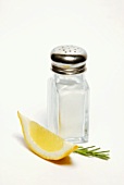 Salt shaker with rosemary and lemon wedge
