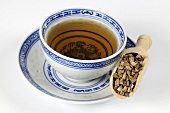 Bowl of tea with dried peel of the green Curaçao orange