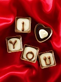 Chocolates on red fabric with the message 'I love you'